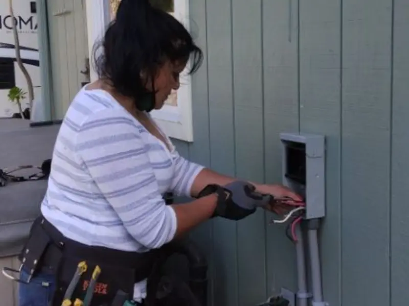 Licensed electrician wiring an exterior subpanel in Plainfield